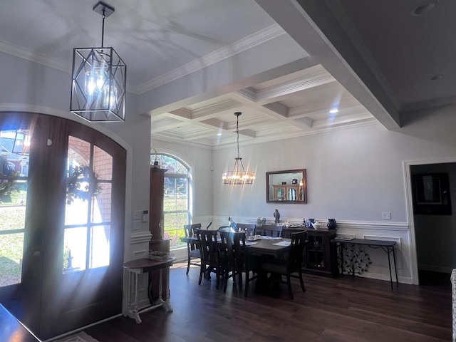 dining area featuring wood finished floors, coffered ceiling, an inviting chandelier, beam ceiling, and crown molding