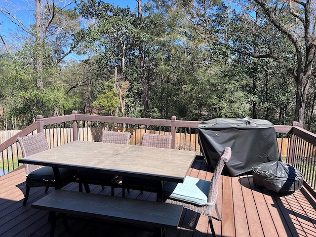 wooden terrace with outdoor dining area