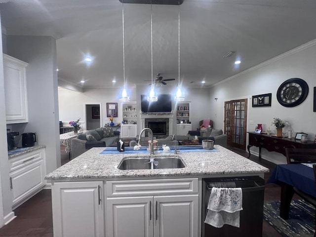 kitchen with a ceiling fan, a center island with sink, a sink, dishwasher, and open floor plan
