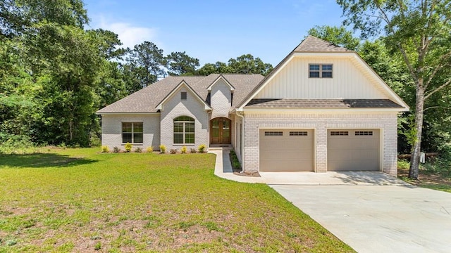 view of front of house featuring brick siding, driveway, a front yard, and an attached garage