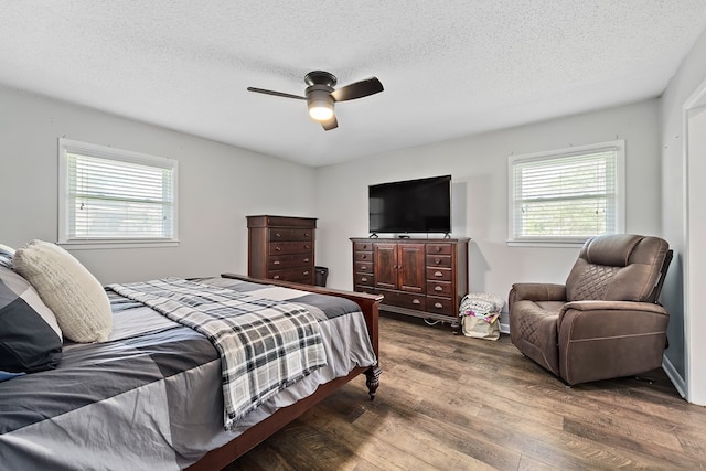 bedroom with wood-type flooring, a textured ceiling, and ceiling fan