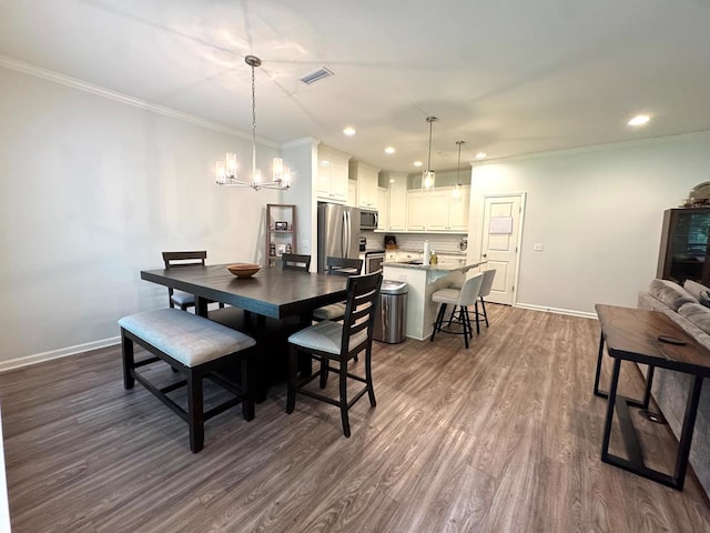 303 Courtland Dr, Dothan, AL 36301 - dining space with dark wood-type flooring, a chandelier, baseboards, ornamental molding, and recessed lighting