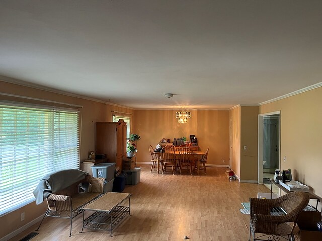 132 Ozark Rd, Abbeville, AL 36310 - living room with ornamental molding, a chandelier, and light wood-style flooring