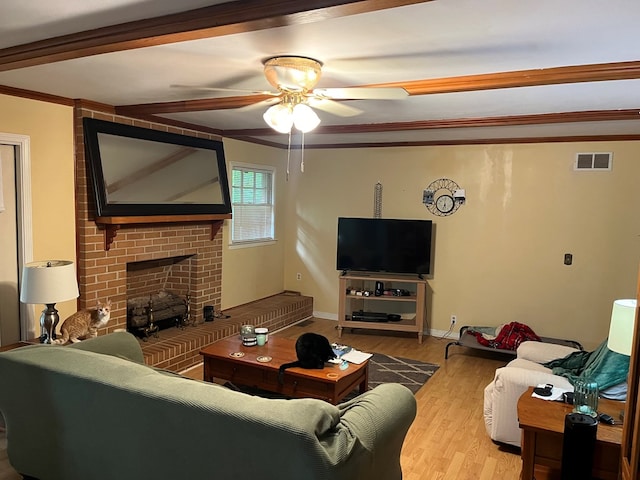 132 Ozark Rd, Abbeville, AL 36310 - living room with a ceiling fan, wood finished floors, a brick fireplace, and ornamental molding