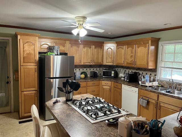 132 Ozark Rd, Abbeville, AL 36310 - kitchen with stainless steel appliances, ceiling fan, backsplash, dark countertops, and ornamental molding