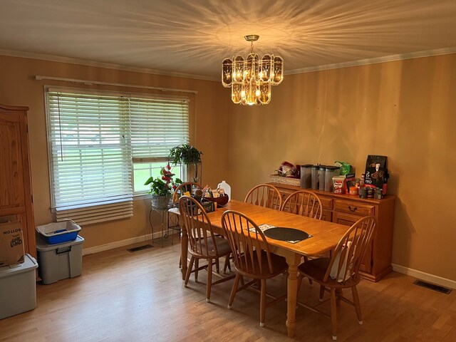 132 Ozark Rd, Abbeville, AL 36310 - dining space with plenty of natural light, a chandelier, light wood-type flooring, and crown molding