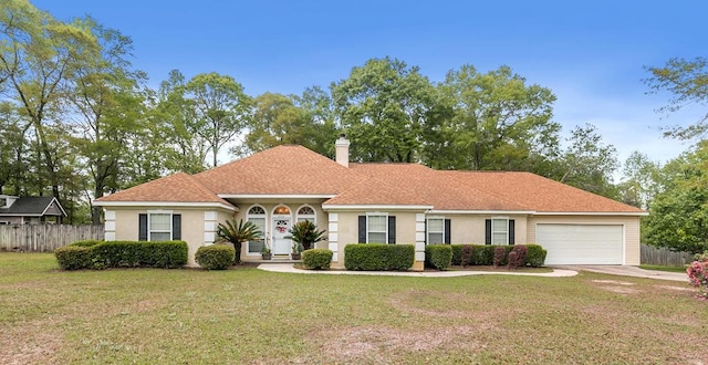 208 Willow Oaks Dr, Headland, AL 36345 - ranch-style house with a front lawn, fence, and stucco siding