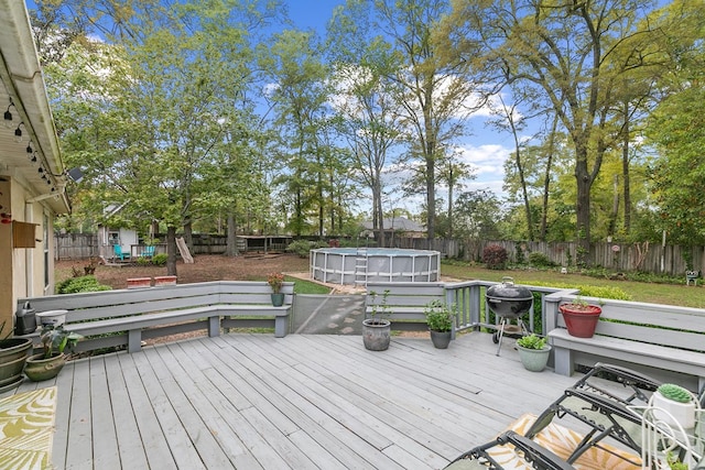 208 Willow Oaks Dr, Headland, AL 36345 - deck with a fenced in pool, a fenced backyard, and area for grilling