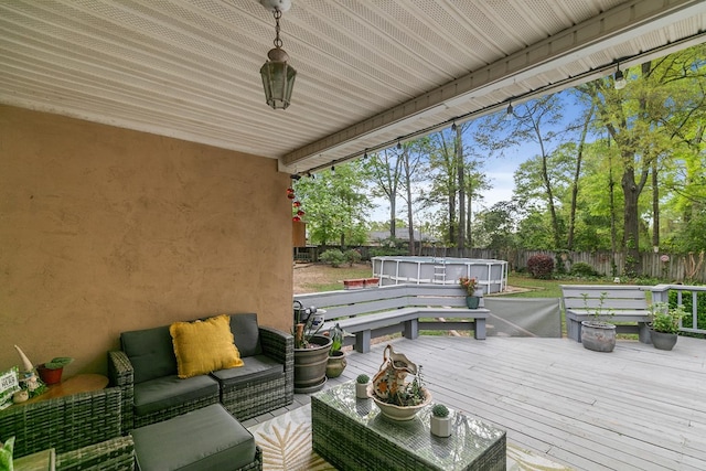 208 Willow Oaks Dr, Headland, AL 36345 - wooden deck featuring a fenced backyard, an outdoor living space, and a fenced in pool