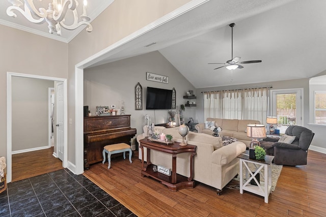 208 Willow Oaks Dr, Headland, AL 36345 - living area featuring baseboards, vaulted ceiling, wood finished floors, and ceiling fan with notable chandelier