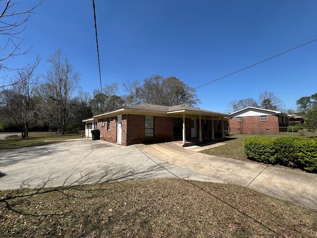 view of front facade featuring concrete driveway and brick siding