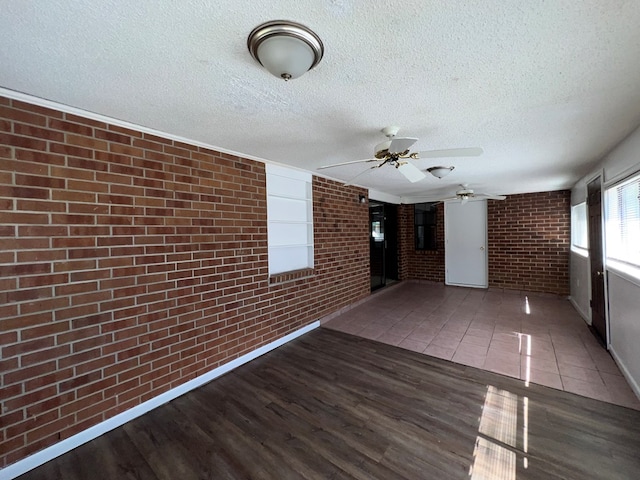 unfurnished sunroom featuring a ceiling fan