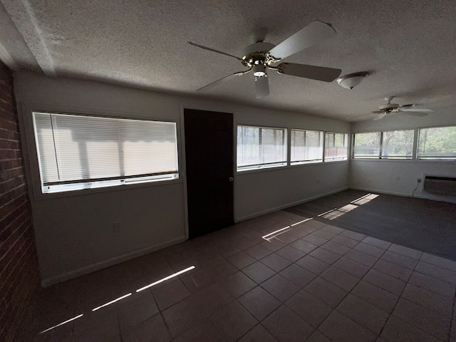 unfurnished sunroom with a ceiling fan