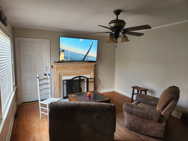 living room featuring crown molding, ceiling fan, and wood-type flooring