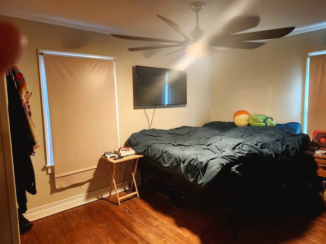 bedroom with wood-type flooring and ceiling fan