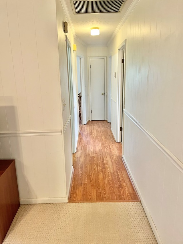 869 Bethlehem Rd, Midland City, AL 36350 - hallway with crown molding, light wood-style flooring, and a decorative wall