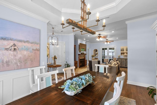 306 Halifax Dr, Dothan, AL 36305 - dining area featuring a chandelier, a ceiling fan, crown molding, wood finished floors, and a tray ceiling