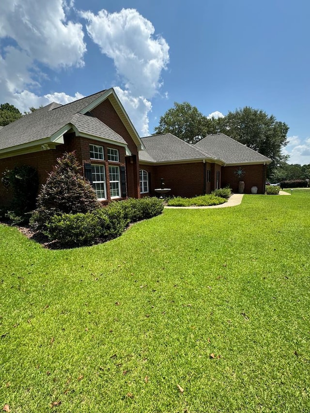 306 Halifax Dr, Dothan, AL 36305 - view of home's exterior featuring a yard, brick siding, and roof with shingles