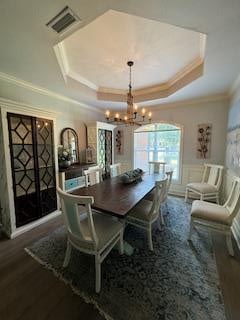 306 Halifax Dr, Dothan, AL 36305 - dining area with ornamental molding, a chandelier, a tray ceiling, wainscoting, and wood finished floors