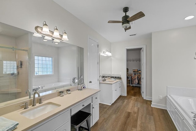 306 Halifax Dr, Dothan, AL 36305 - bathroom with a bath, a stall shower, wood finished floors, and vanity