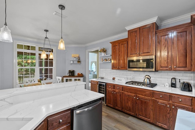 306 Halifax Dr, Dothan, AL 36305 - kitchen featuring appliances with stainless steel finishes, backsplash, decorative light fixtures, and ornamental molding