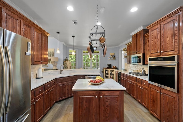 306 Halifax Dr, Dothan, AL 36305 - kitchen featuring stainless steel appliances, light wood-type flooring, crown molding, decorative backsplash, and recessed lighting