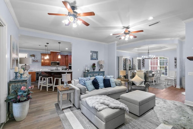 306 Halifax Dr, Dothan, AL 36305 - living room with ceiling fan, wine cooler, light wood finished floors, crown molding, and a chandelier