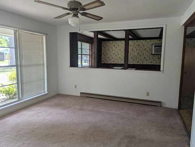 108 Imperial Dr, Eufaula, AL 36027 - carpeted spare room featuring a baseboard heating unit, an AC wall unit, and ceiling fan