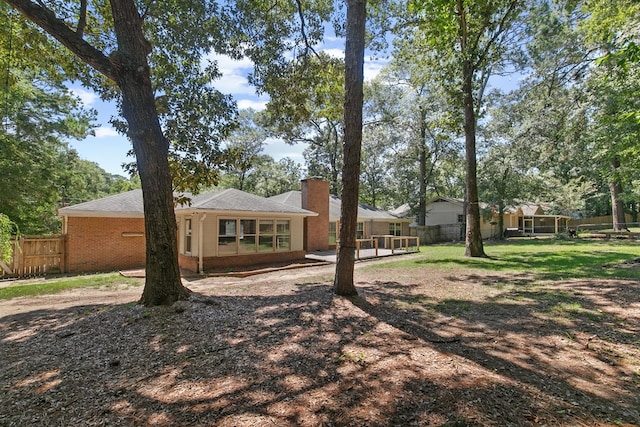 1005 Rampart Dr, Dothan, AL 36303 - back of property with a chimney, brick siding, and a deck