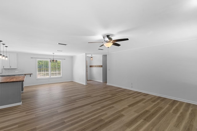 1005 Rampart Dr, Dothan, AL 36303 - unfurnished living room featuring a ceiling fan, wood finished floors, and a chandelier