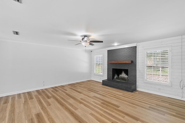 1005 Rampart Dr, Dothan, AL 36303 - unfurnished living room with a ceiling fan, light wood finished floors, and a fireplace