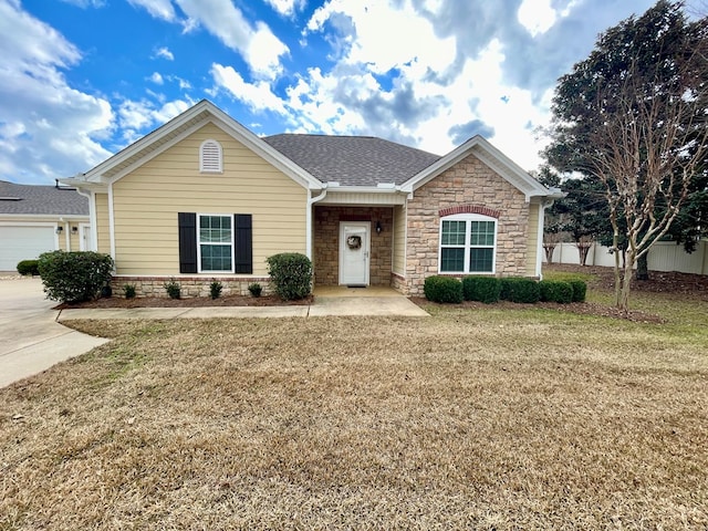 view of front of house featuring a front yard and a garage