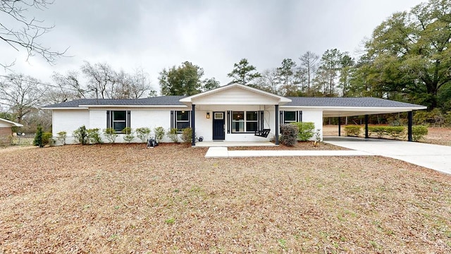 ranch-style home with a carport and a porch