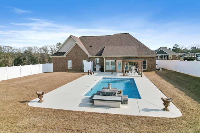 view of pool with area for grilling, a yard, and a patio area