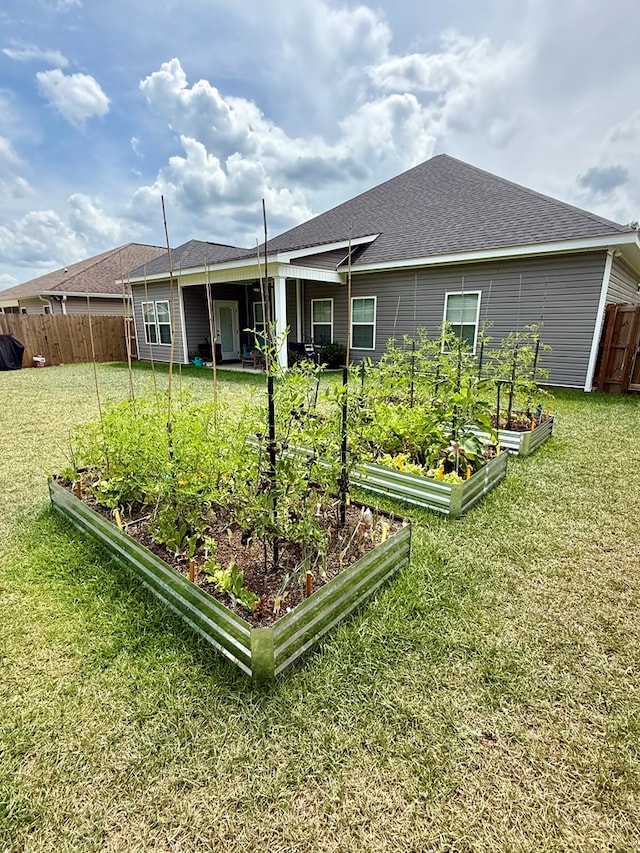 106 Sandpiper Ln, Dothan, AL 36301 - back of house featuring a vegetable garden and roof with shingles