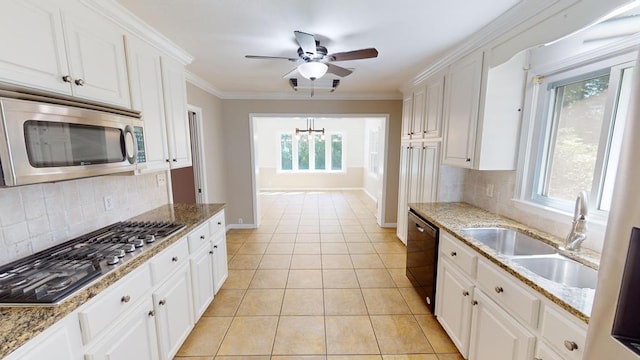 kitchen featuring sink, white cabinets, stainless steel appliances, and plenty of natural light