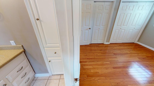 interior space with hardwood / wood-style floors and vanity