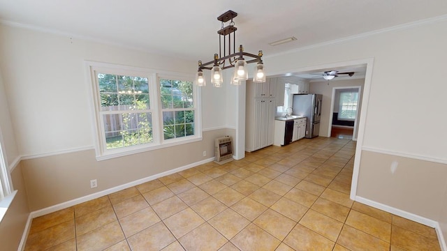 unfurnished dining area with heating unit, ceiling fan, plenty of natural light, and light tile patterned floors