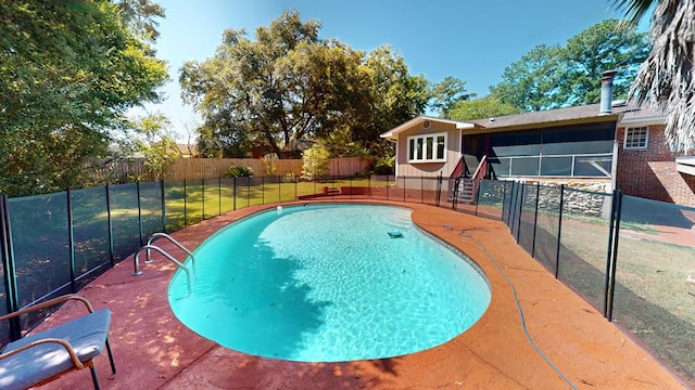 view of pool with a lawn