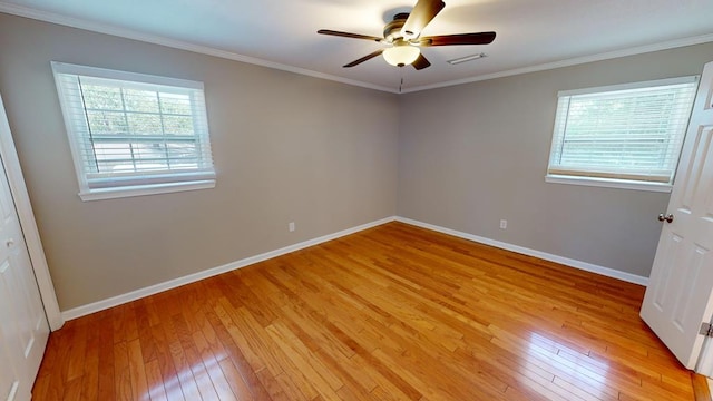 unfurnished room with a wealth of natural light, crown molding, and light hardwood / wood-style floors