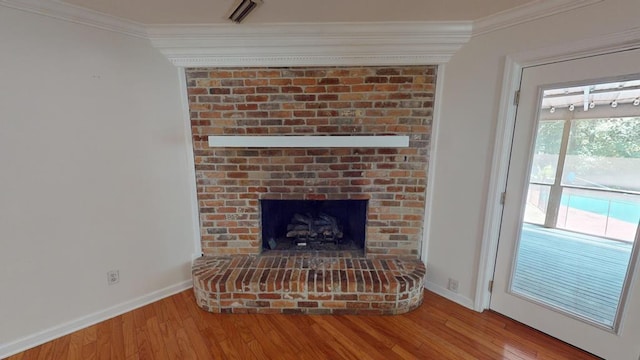 room details with hardwood / wood-style floors, ornamental molding, and a fireplace