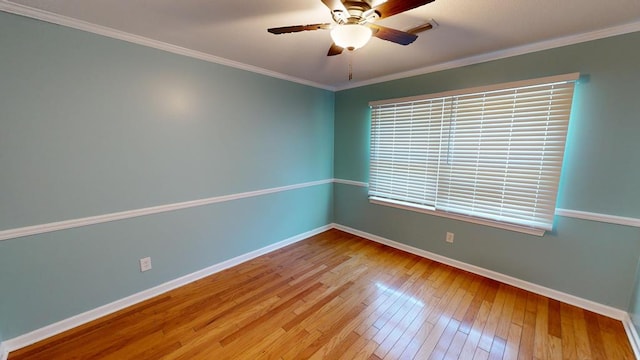 empty room featuring ceiling fan, hardwood / wood-style floors, and ornamental molding