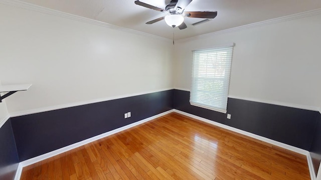 empty room featuring hardwood / wood-style floors, ceiling fan, and ornamental molding