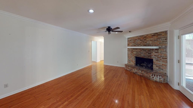 unfurnished living room with ceiling fan, a fireplace, crown molding, and light hardwood / wood-style flooring