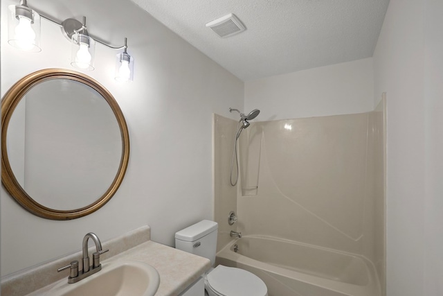 full bathroom with vanity, tub / shower combination, a textured ceiling, and toilet