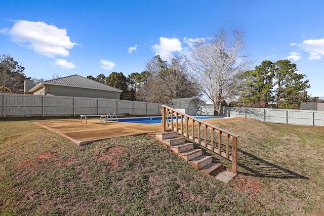 view of yard featuring a fenced in pool and a patio