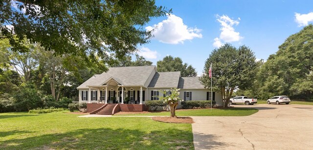 rear view of house featuring a lawn, a patio, and french doors