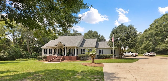 ranch-style house with a front lawn and covered porch