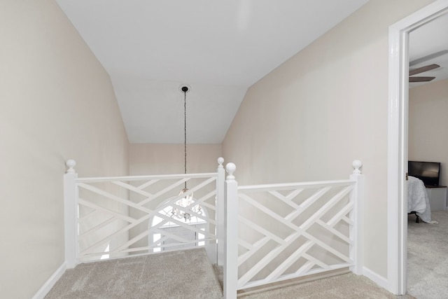 staircase with carpet floors and vaulted ceiling