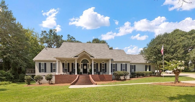 ranch-style home with a porch and a front lawn